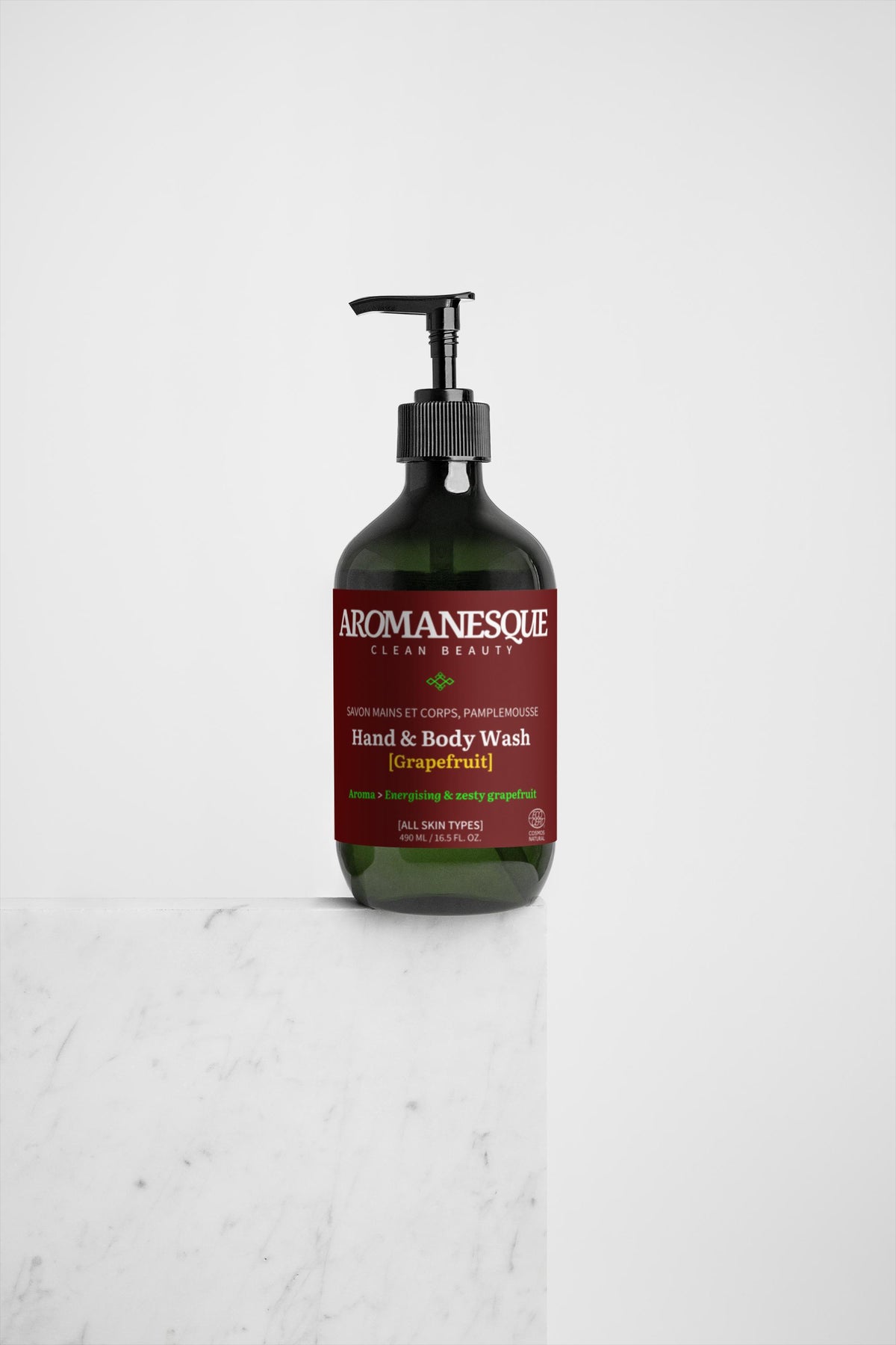 A pump bottle of Aromanesque Hand & Body Wash with a grapefruit scent, featuring red and white labeling.