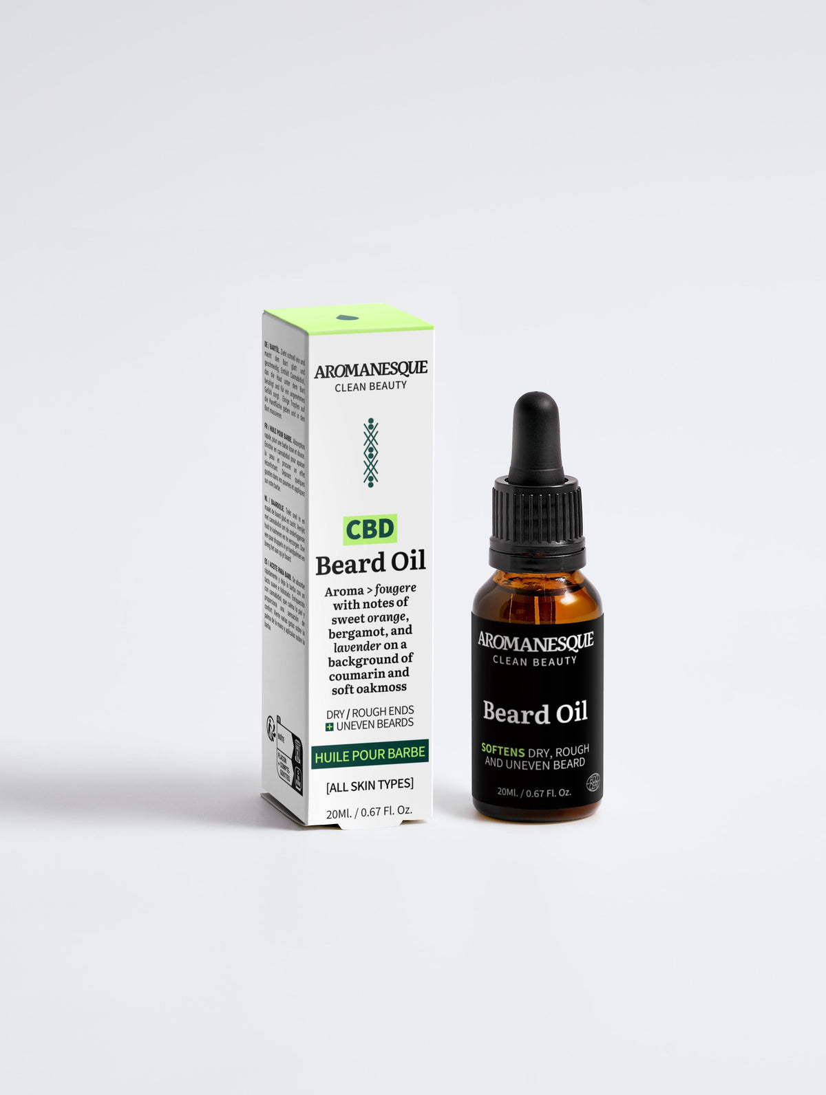 A bottle of Aromanesque Beard Oil with its packaging box. The bottle is amber-colored with a dropper, and the box is green and white with product information.